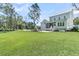 Expansive backyard with lush green lawn, patio, and outdoor fireplace, creating a serene outdoor living space at 3864 Summerton St, Mount Pleasant, SC 29466