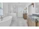 Bright bathroom with dual sinks, soaking tub and glass-enclosed shower with marble floors at 3864 Summerton St, Mount Pleasant, SC 29466