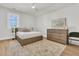 Bright bedroom with light wood floors, area rug, ceiling fan and large dresser at 3864 Summerton St, Mount Pleasant, SC 29466