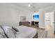 Bright bedroom with light wood floors, ceiling fan and built-in desk with a television at 3864 Summerton St, Mount Pleasant, SC 29466