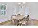Elegant dining room with large windows, plantation shutters, stylish chandelier, and seating for eight at 3864 Summerton St, Mount Pleasant, SC 29466