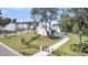 Charming white home with a private driveway, a well-manicured lawn and mature trees at 3864 Summerton St, Mount Pleasant, SC 29466