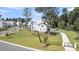 Beautiful white home featuring a manicured lawn, black fencing, mature trees and a long private driveway at 3864 Summerton St, Mount Pleasant, SC 29466