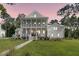 Inviting two-story white home with a welcoming porch and well-manicured lawn, great for relaxing outdoors at 3864 Summerton St, Mount Pleasant, SC 29466