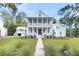 Charming two-story home with a inviting front porch and beautiful landscaping, offering curb appeal at 3864 Summerton St, Mount Pleasant, SC 29466