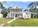 Charming two-story home with a inviting front porch, beautiful lawn and classic architectural details at 3864 Summerton St, Mount Pleasant, SC 29466