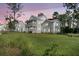 Charming two-story white home featuring a spacious porch, lush lawn, and inviting curb appeal at 3864 Summerton St, Mount Pleasant, SC 29466