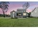 Exterior rear view of a charming home featuring a screened porch and outdoor fireplace at 3864 Summerton St, Mount Pleasant, SC 29466