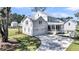 Backyard view of a beautiful white home with a screened porch and a two-car garage at 3864 Summerton St, Mount Pleasant, SC 29466