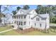 Stunning exterior view of a modern two-story home with a metal roof, double porches, and manicured landscaping at 3864 Summerton St, Mount Pleasant, SC 29466