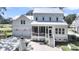 Back view of a beautiful white home with a screened porch, outdoor stairs, and a two-car garage at 3864 Summerton St, Mount Pleasant, SC 29466