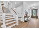 Spacious foyer featuring a staircase, custom built-ins, hardwood floors, and a stylish console table at 3864 Summerton St, Mount Pleasant, SC 29466