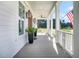 Inviting front porch featuring classic lanterns, a ceiling fan, and views of the manicured lawn at 3864 Summerton St, Mount Pleasant, SC 29466