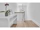 Bright hallway with white wooden railings, hardwood floor and an orchid plant decoration at 3864 Summerton St, Mount Pleasant, SC 29466