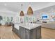 Spacious kitchen island with marble countertop, farmhouse sink, and modern pendant lighting fixtures at 3864 Summerton St, Mount Pleasant, SC 29466
