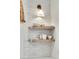 Floating wooden shelves display dishes against a white tiled wall, illuminated by a sconce at 3864 Summerton St, Mount Pleasant, SC 29466