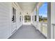 Inviting covered porch featuring classic white columns and serene views of the surrounding landscape at 3864 Summerton St, Mount Pleasant, SC 29466