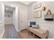 Inviting hallway with hardwood floors, stylish decor, and a comfortable bench at 408 Katies Scenic Ct, Charleston, SC 29492