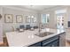 A stylish kitchen featuring an island with counter seating, modern appliances, and sleek design at 408 Katies Scenic Ct, Charleston, SC 29492