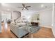 Open-concept living room featuring hardwood floors, neutral-toned furniture, and a staircase at 408 Katies Scenic Ct, Charleston, SC 29492