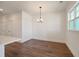 Open concept dining room with modern chandelier, hardwood floors, and a window at 410 Katies Scenic Ct, Charleston, SC 29492