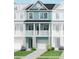 Charming three-story townhome with a two-story porch, blue siding, white trim, and well-manicured landscaping at 410 Katies Scenic Ct, Charleston, SC 29492