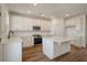 Bright kitchen with stainless steel appliances, white cabinetry, a kitchen island, and hardwood floors at 410 Katies Scenic Ct, Charleston, SC 29492