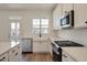 Beautiful kitchen with white cabinets, quartz countertops, stainless appliances, and hardwood floors at 410 Katies Scenic Ct, Charleston, SC 29492