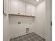 Neat laundry room featuring decorative tile floors, bright lighting, and functional cabinetry at 410 Katies Scenic Ct, Charleston, SC 29492