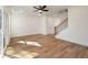 Bright living room with hardwood floors, ceiling fan, and staircase with wooden banister at 410 Katies Scenic Ct, Charleston, SC 29492