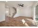 Open-concept living room with hardwood floors, ceiling fan, and staircase leading to upper level at 410 Katies Scenic Ct, Charleston, SC 29492