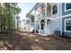 Rear exterior view of townhomes with screened porches and well-manicured lawns at 410 Katies Scenic Ct, Charleston, SC 29492