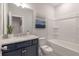 Bathroom featuring a navy blue vanity, white marble countertop, and bathtub with shower at 412 Katies Scenic Ct, Charleston, SC 29492