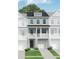 Charming three-story home featuring a front porch, garage, and a well-maintained lawn at 412 Katies Scenic Ct, Charleston, SC 29492