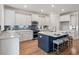 Modern kitchen with a large center island, white cabinets, and blue backsplash at 412 Katies Scenic Ct, Charleston, SC 29492