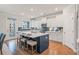 Modern kitchen with a large center island, white cabinets, and blue backsplash at 412 Katies Scenic Ct, Charleston, SC 29492
