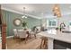 This open concept shows the kitchen, dining and living spaces with luxury vinyl plank flooring at 414 Duskywing Dr, Goose Creek, SC 29445