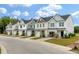New townhome exteriors feature manicured lawns, individual garages, and complementary color schemes at 414 Duskywing Dr, Goose Creek, SC 29445