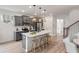 Modern kitchen features gray cabinets, stainless steel appliances, and an island with bar seating at 414 Duskywing Dr, Goose Creek, SC 29445