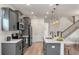 Modern kitchen featuring gray cabinets, stainless steel appliances, and a large island with pendant lighting at 414 Duskywing Dr, Goose Creek, SC 29445