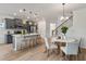 The open concept features a kitchen with a large island, stool seating and modern light fixtures at 414 Duskywing Dr, Goose Creek, SC 29445