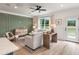 The open living room is filled with natural light and features luxury vinyl plank flooring at 414 Duskywing Dr, Goose Creek, SC 29445