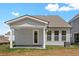 Exterior back view of home with covered patio, windows, and neutral siding at 417 Grove End Rd, Moncks Corner, SC 29461