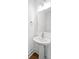 Elegant pedestal sink with modern mirror and lighting fixtures in the half bath at 417 Grove End Rd, Moncks Corner, SC 29461