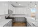 Kitchen featuring white cabinets, gray lower cabinets, and stainless-steel appliances at 417 Grove End Rd, Moncks Corner, SC 29461