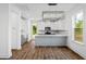 Modern kitchen with white cabinets, gray island, stainless steel appliances, and stylish pendant lighting at 417 Grove End Rd, Moncks Corner, SC 29461