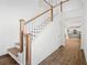 Bright staircase with hardwood steps, white risers, and wooden handrails leads to an open floor plan at 417 Grove End Rd, Moncks Corner, SC 29461