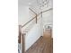 Open staircase with wood and white railing overlooks an open-concept kitchen at 417 Grove End Rd, Moncks Corner, SC 29461