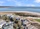 Picturesque aerial view of coastal homes near a pristine beach, highlighting the community's desirable waterfront location at 45 Ocean Point Dr, Isle of Palms, SC 29451