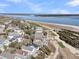 Scenic aerial view of coastal homes adjacent to a golf course and the ocean, showcasing a beautiful seaside community at 45 Ocean Point Dr, Isle of Palms, SC 29451